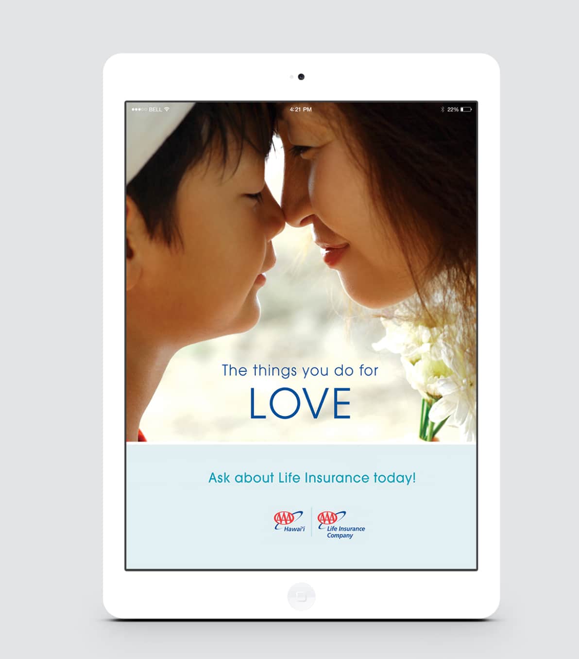 A digital tablet displaying an advertisement for life insurance with a close-up image of a mother and child affectionately touching noses, with a tagline about love.