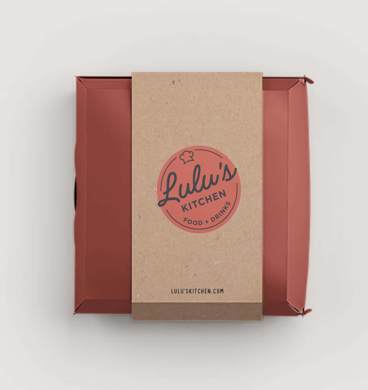 A carry-out bag from Lulu's Kitchen with the restaurant's logo on a kraft paper background, hinting at a takeout or delivery service.