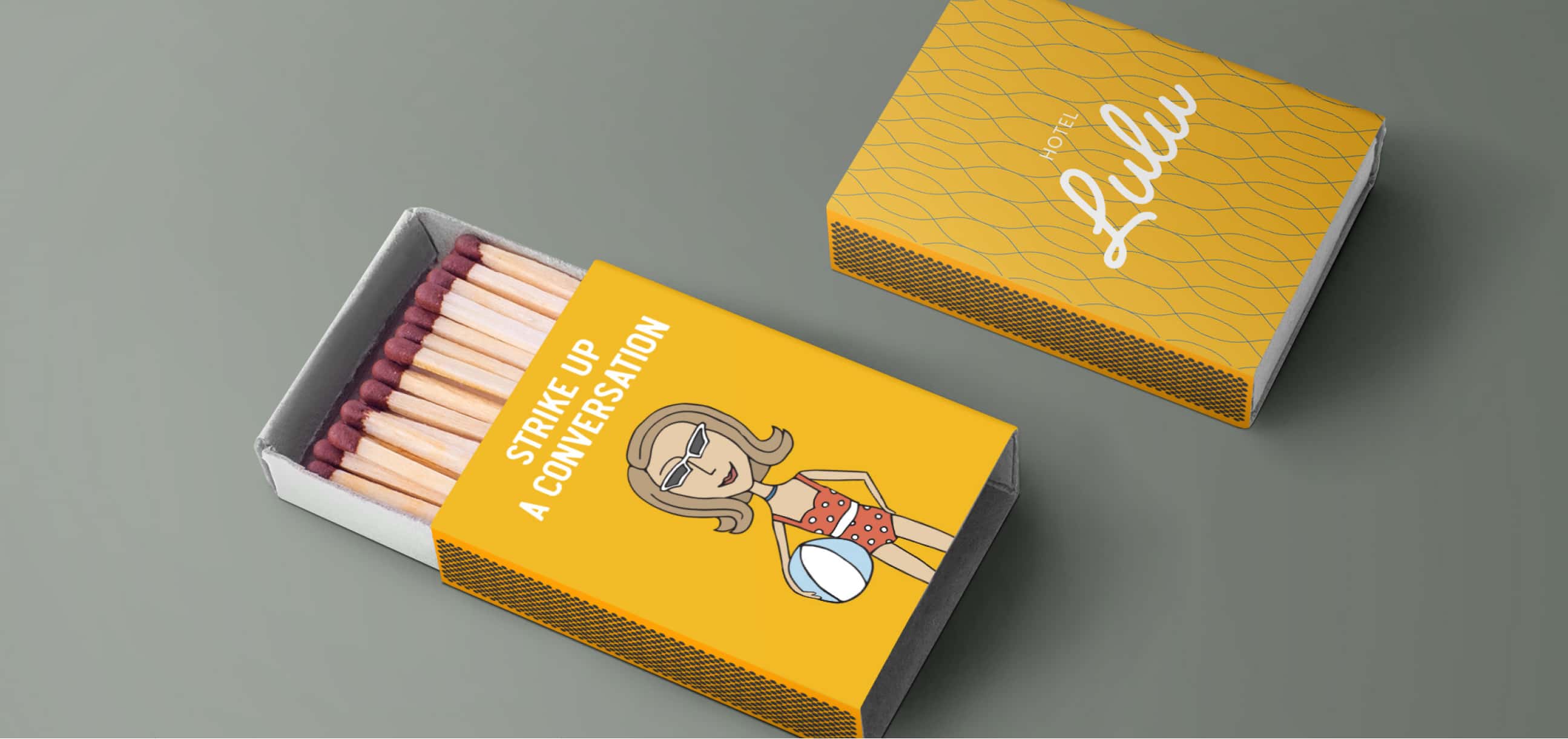 An open matchbox with a design from Hotel Lulu, featuring the text 'STRIKE UP A CONVERSATION' and an illustration of a woman with a cocktail, against a yellow and diamond-patterned background.